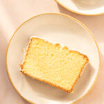 Slice of lemon loaf cake on a white plate.