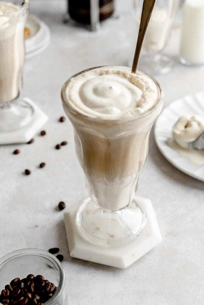 Image of German iced coffee - aka Eiskaffee - in a milkshake glass topped with whipped cream.
