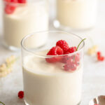 45 degree image of bavarian cream in a 8 oz glass topped with raspberries and red currants.