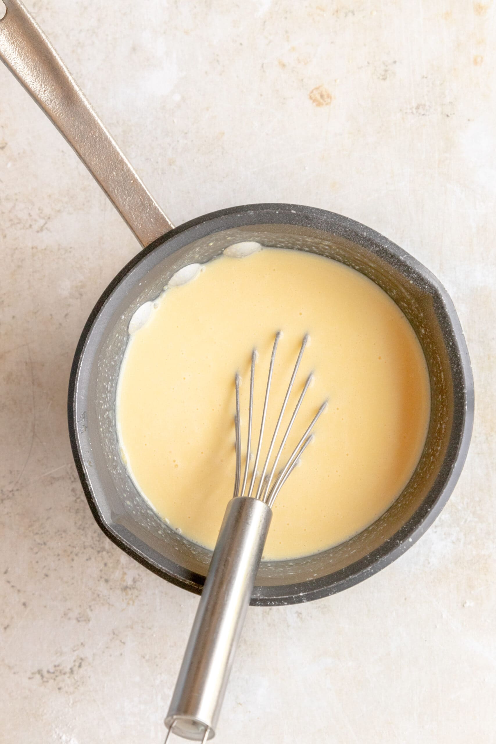 vanilla pudding with milk and cornstarch in a sauce pot.