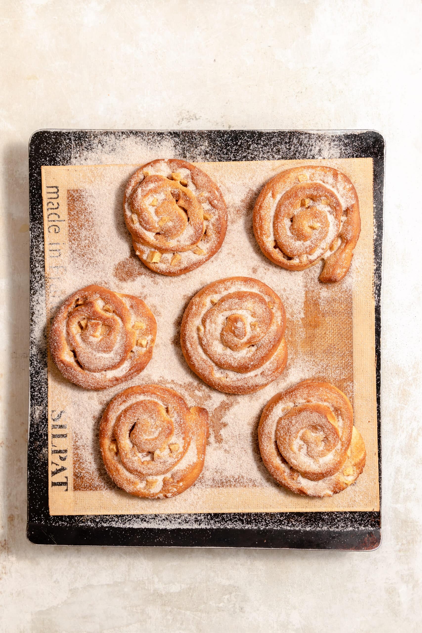 Overhead image of the apfelschnecken freshly baked and sprinkled with cinnamon sugar.