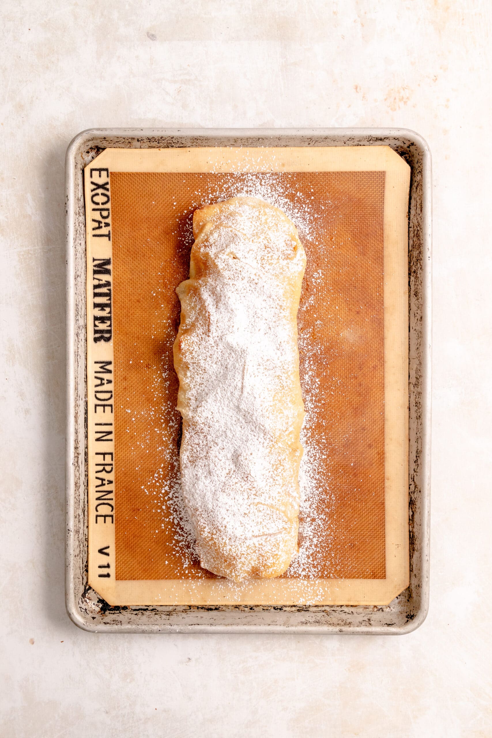 Baked apple strudel dusted with powdered sugar.