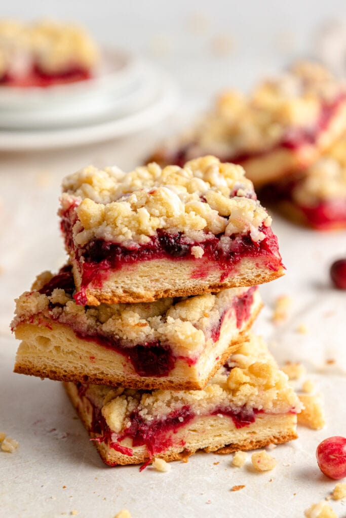 Side view of 3 squares of Cranberry Streuselkuchen stacked on top of each other.
