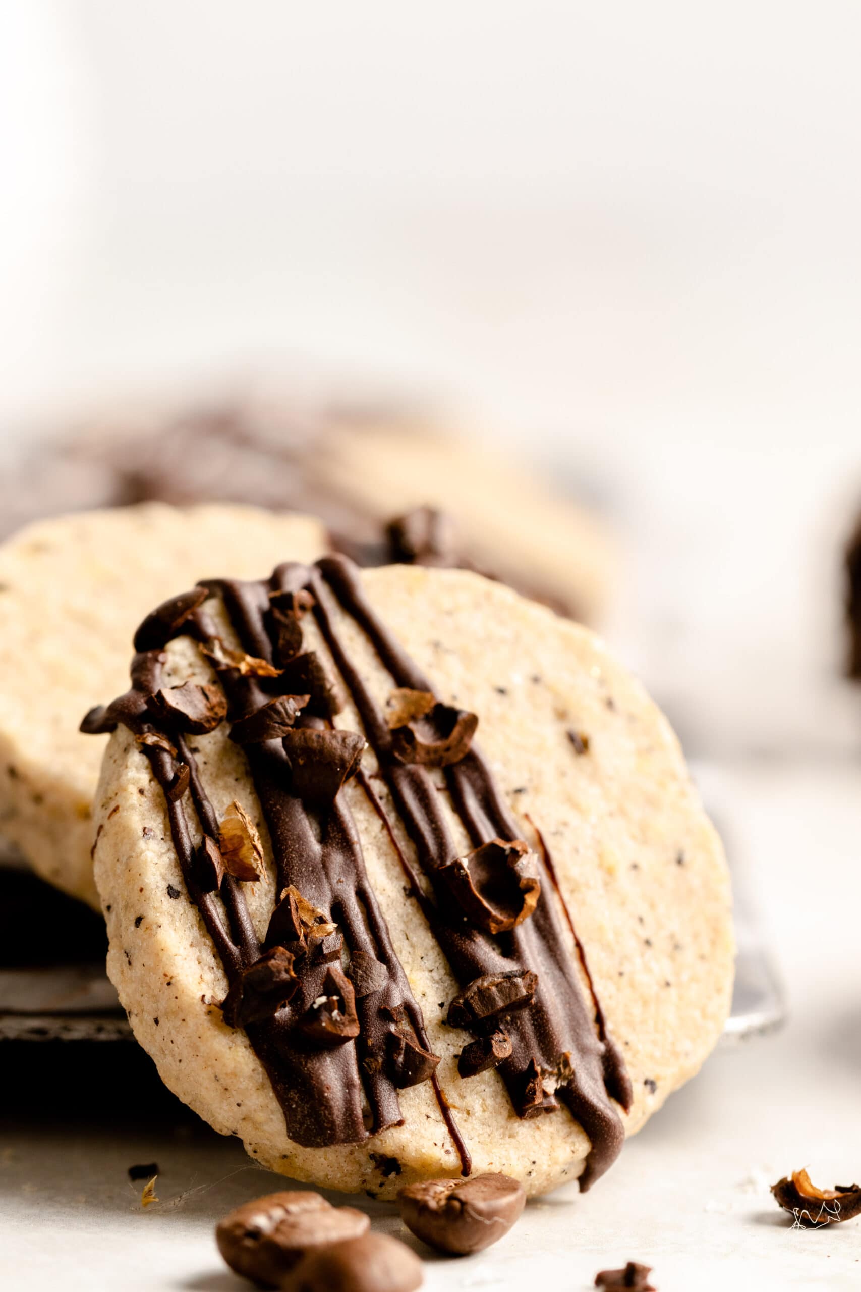 Side view of Slice and Bake espresso cookie with chocolate drizzle and chopped espresso.