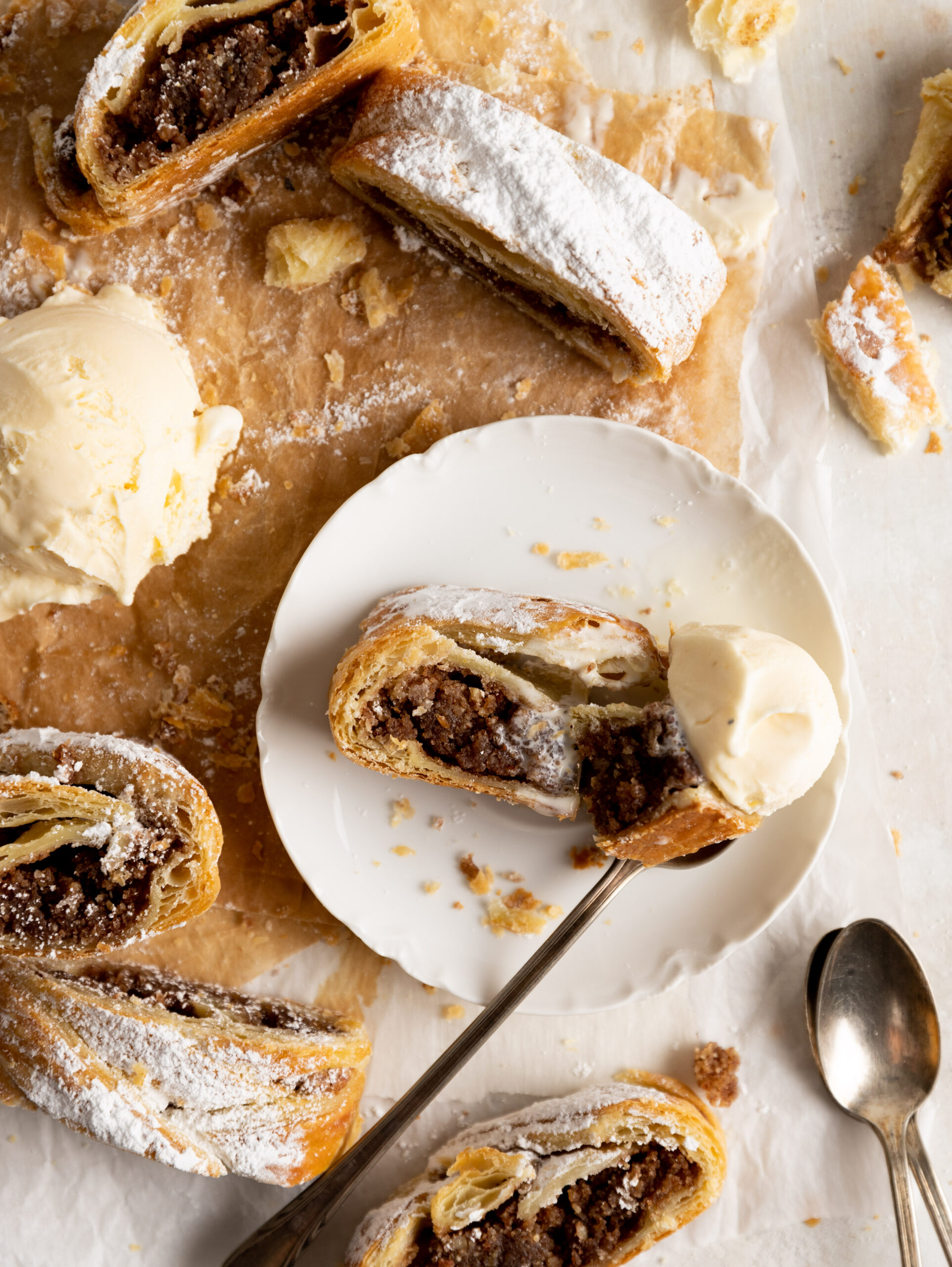 Overhead image of multiple slices of Puff Pastry Nut Strudel with ice cream 