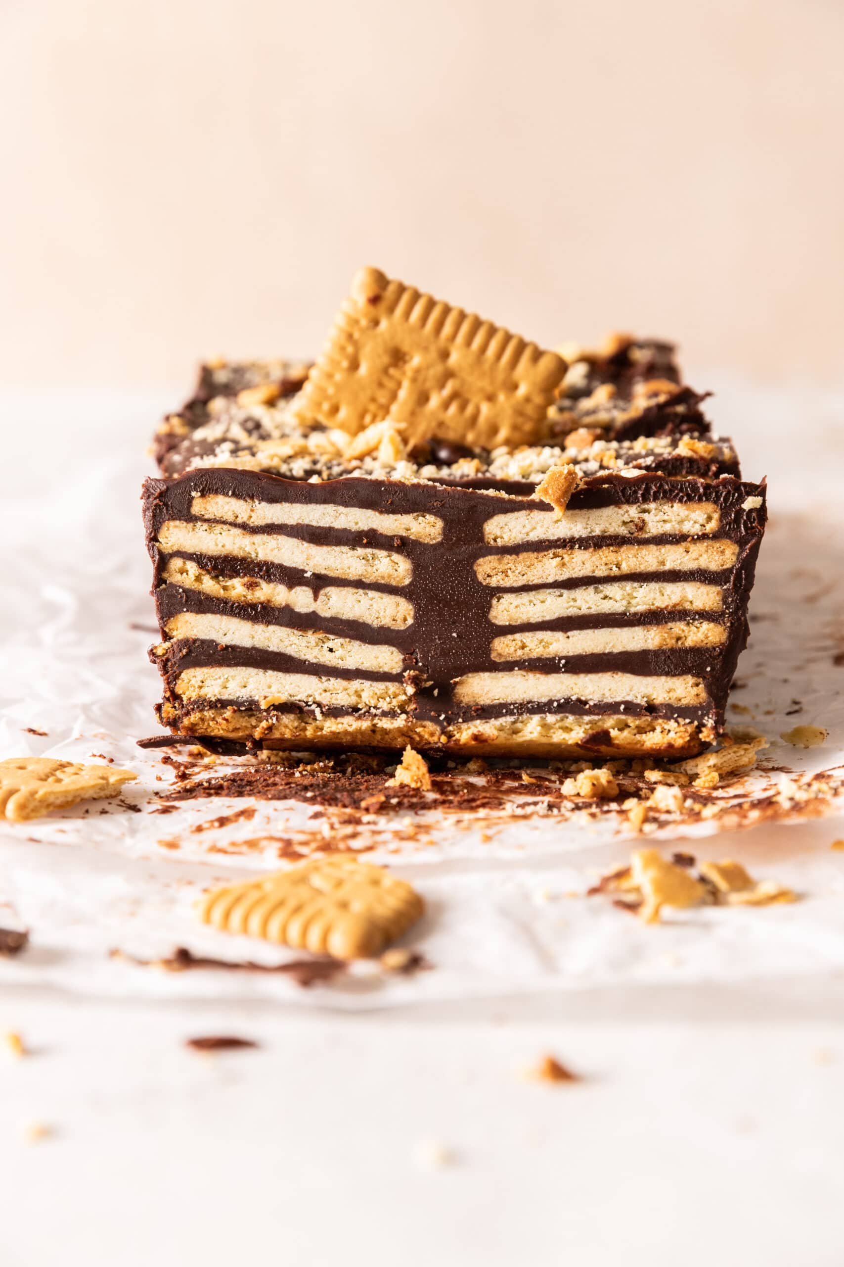Side view of a slice of Kalter Hund where the layers of cookie and chocolate are visible. 