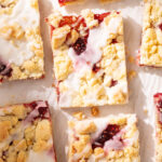 Overhead view of raspberry streusel bars baked on puff pastry with lemon glaze.
