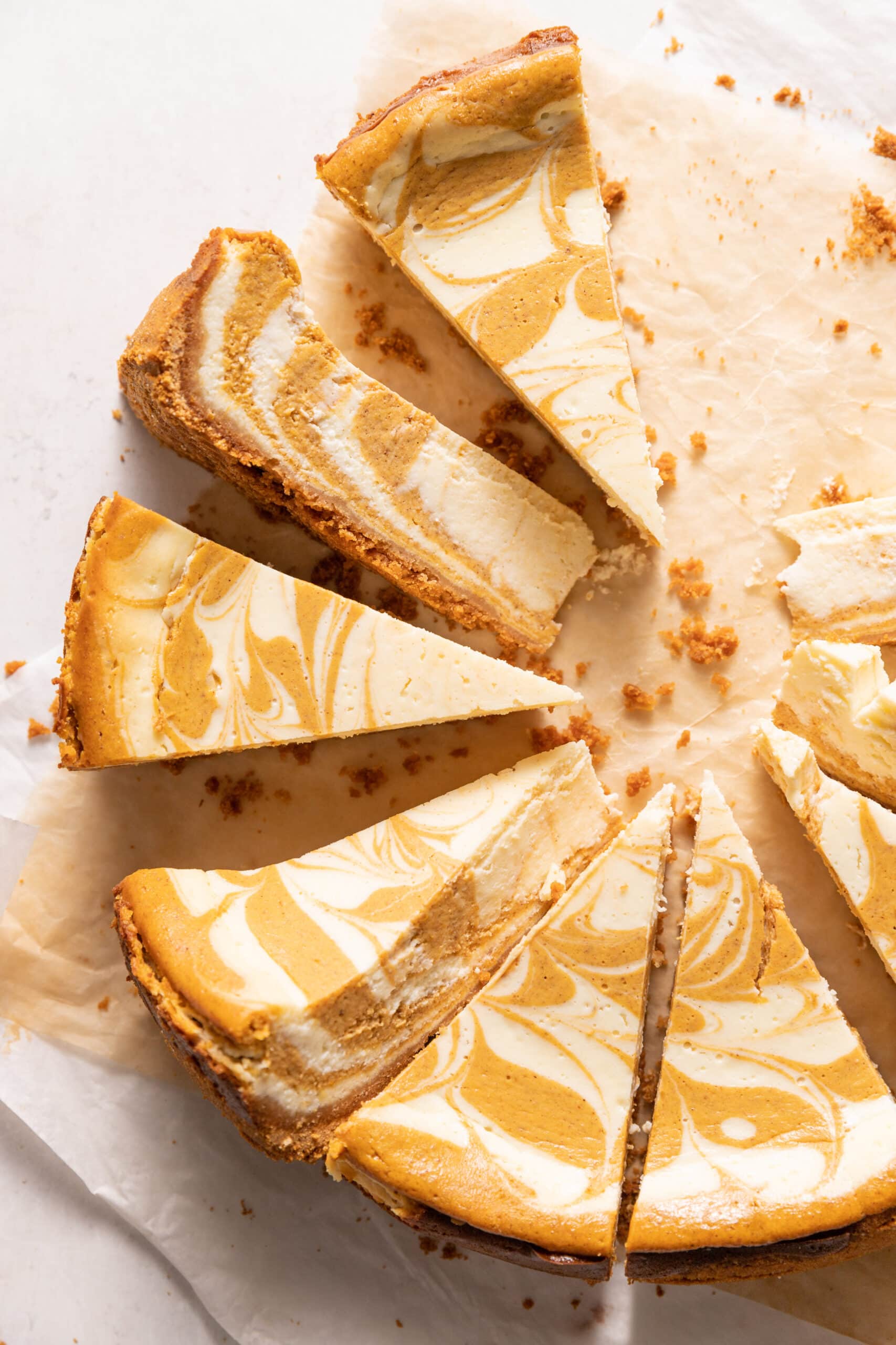 Overhead view of pumpkin swirl cheesecake cut into slices.