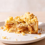 Side view of a thick slice of German Apple Pie with a streusel topping.