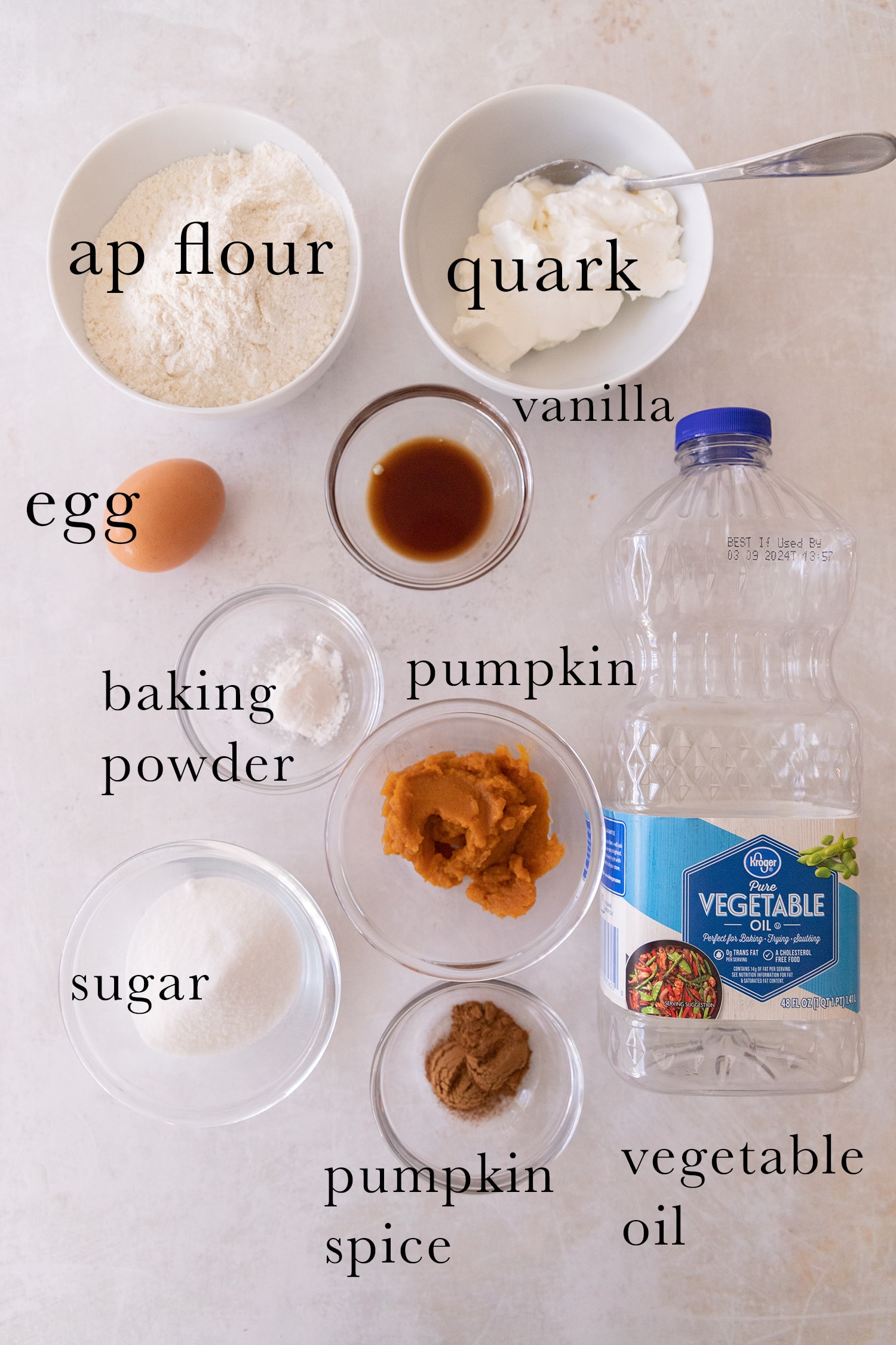 Ingredients for pumpkin spice donut holes laid out on a table and listed.