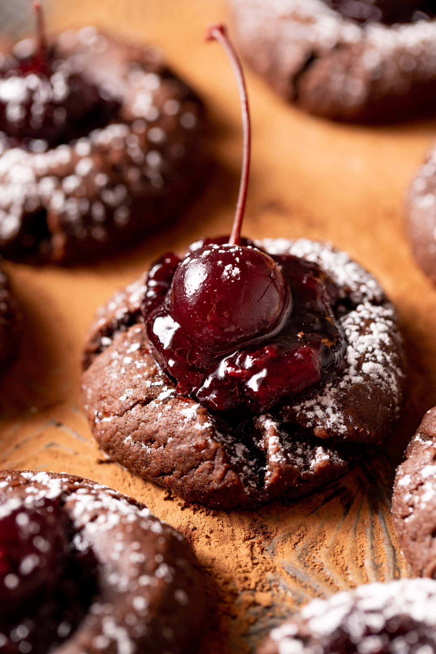Side view of Chocolate Cherry Cookies with a bourbon cherry in the center. 
