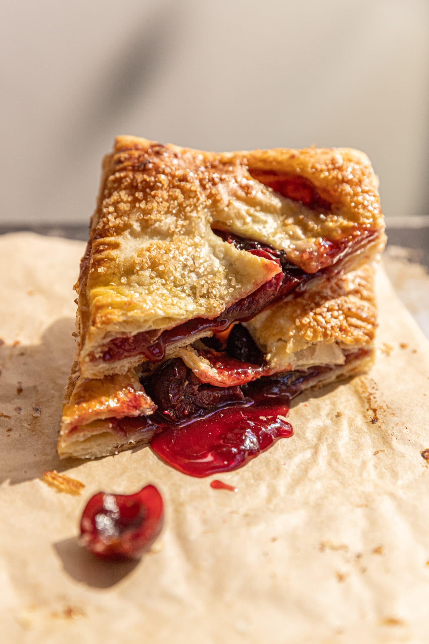 Puff Pastry cherry hand pie cut in half with the filling visible. 