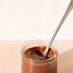Little glass pot filled with the best chocolate pudding and a long thin spoon.