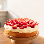 Strawberries & Cream Cake on a ceramic cake stand.