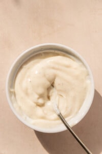 Creamy homemade vanilla pudding in. a white ramekin.