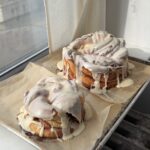Side view of two tiers of a cinnamon roll cake before stacking.