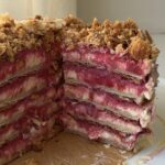 Side view of a Rhubarb napoleon cake with slices cut out showing off the layers.