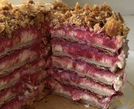 Side view of a Rhubarb napoleon cake with slices cut out showing off the layers.