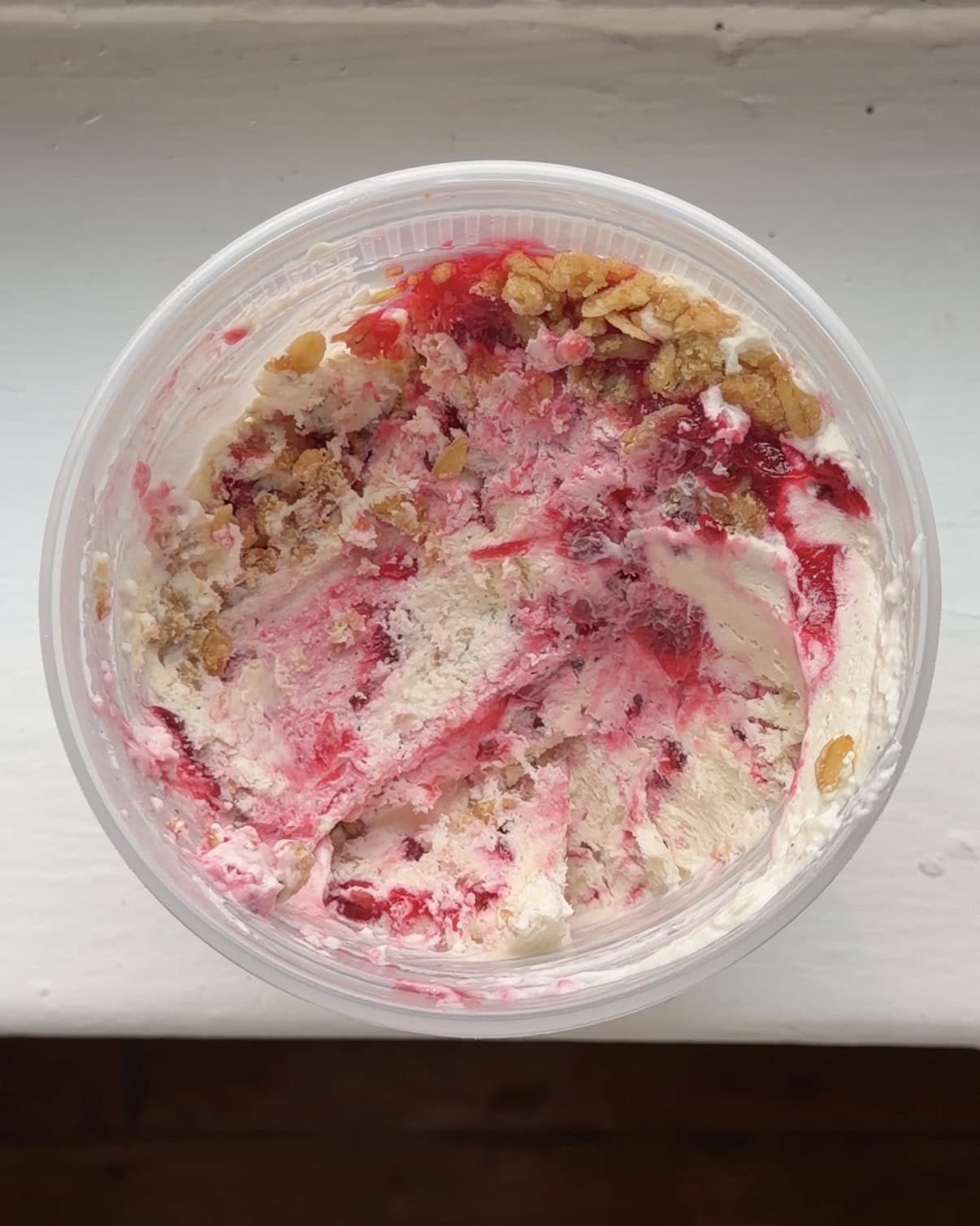 Overhead view of a pint container of Red Currant Crisp Ice Cream.