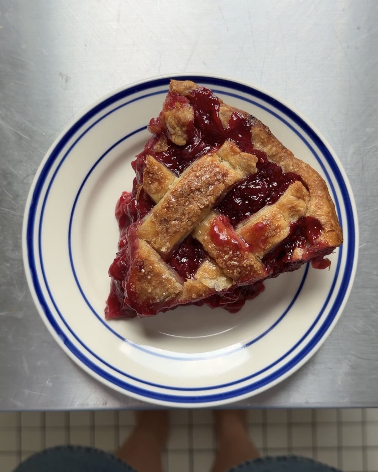 Overhead view of a slice of cherry pie.