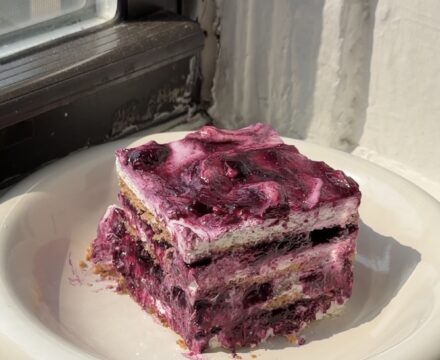 Side view of a slice of Lemon Blueberry Icebox Cake one a white plate.