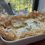 Side view of a baking dish full of Spanakopita Quiche.