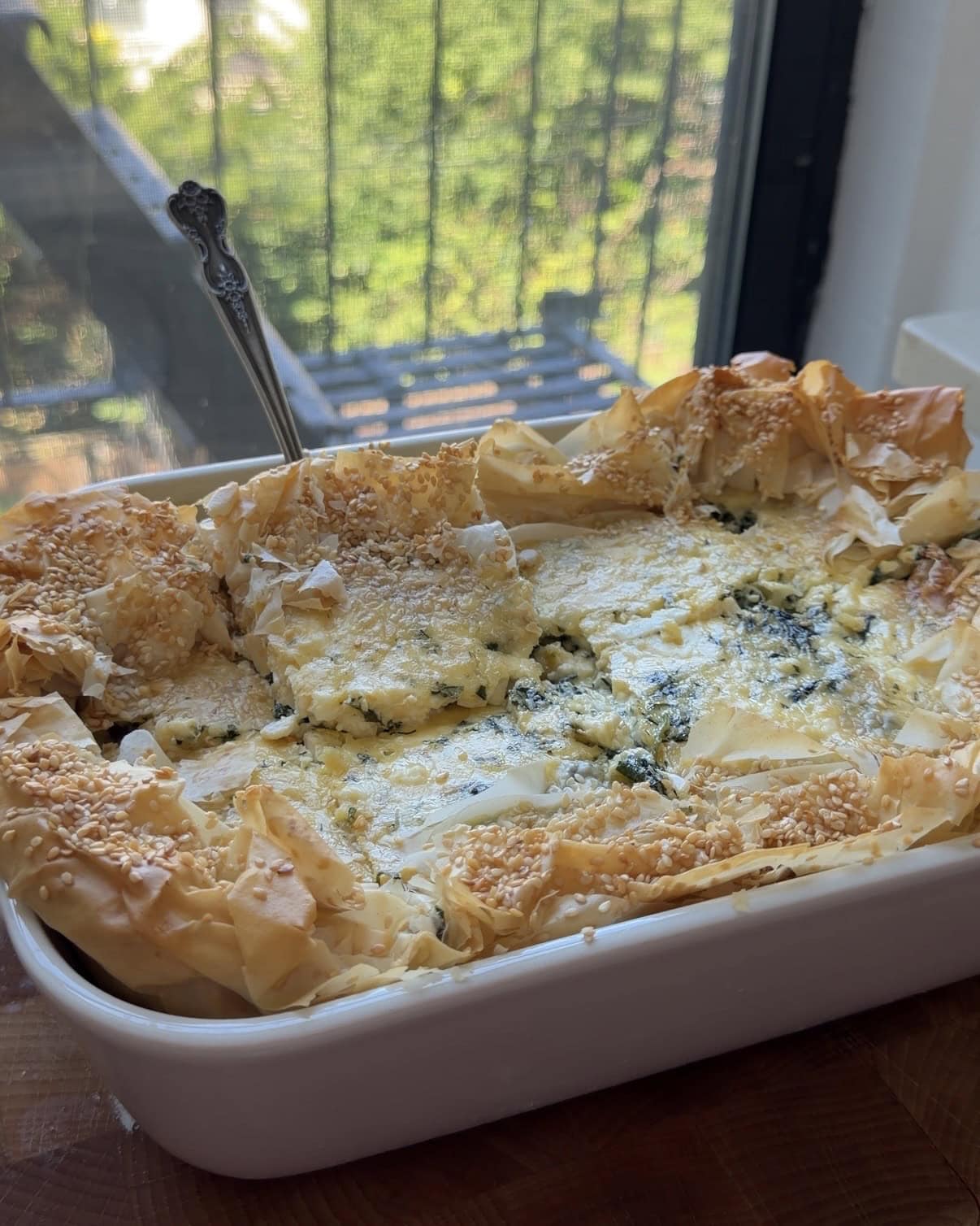 Side view of a baking dish full of Spanakopita Quiche.