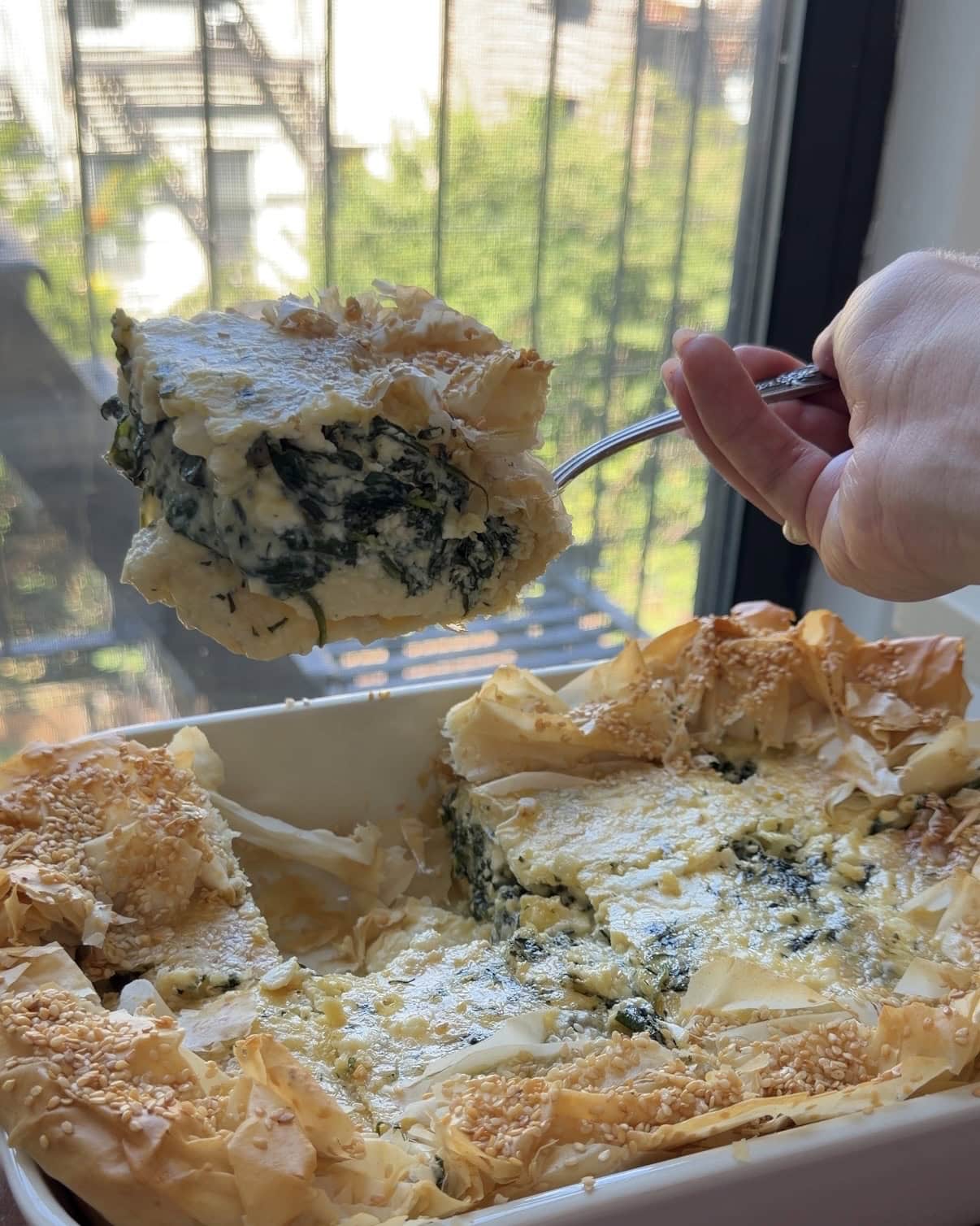 Side view of a slice of spanakopita quiche.